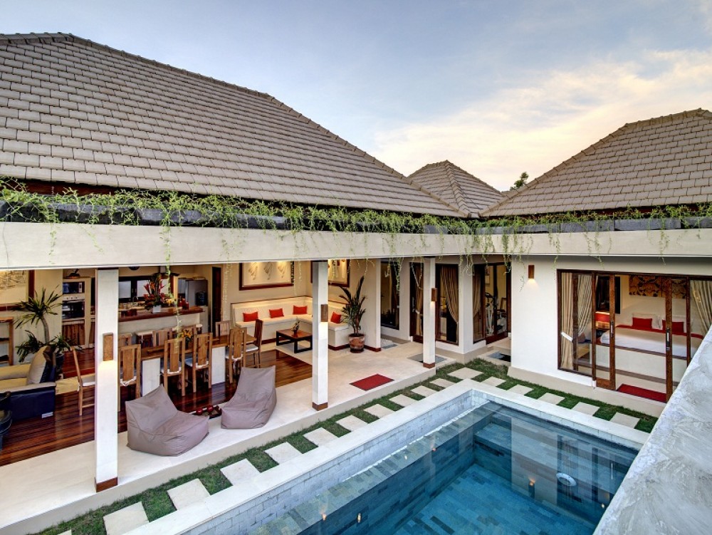 Bali family villas. relaxing pool side with a comfort bean bag